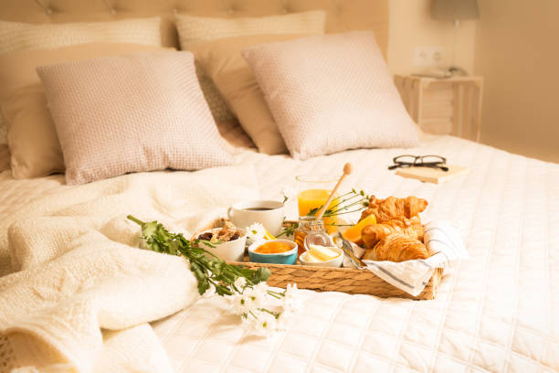 istock Continental breakfast on bed in elegant bedroom interior 1131097077