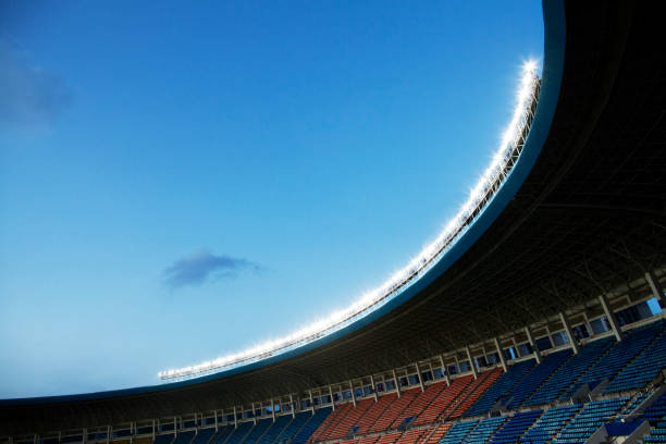 istock Spotlights and floodlights at a stadium at dusk 1131097355