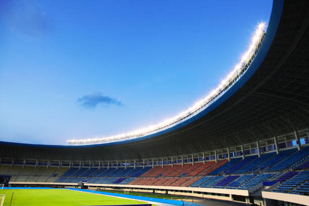 istock Floodlights at an empty stadium in China at dusk 1131097384