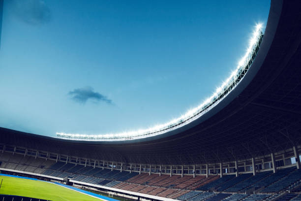 istock Spotlights and floodlights at an empty stadium at dusk 1131097404