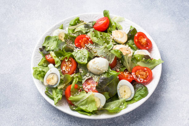 istock Fresh salad with tomatoes and quail eggs and lettuce. 1131097540