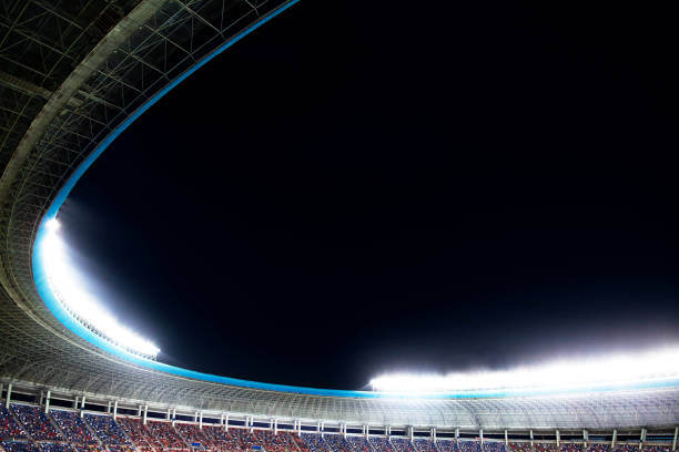 istock Spotlights and floodlights at a stadium at night 1131098512