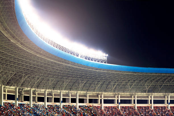 istock Spotlights and floodlights at a stadium at night 1131098527