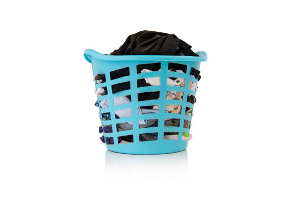 istock Clothes in a laundry wooden basket on white background 1131098800