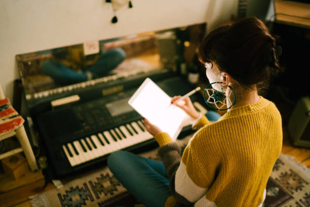 istock Young woman composing new music at home 1131098954