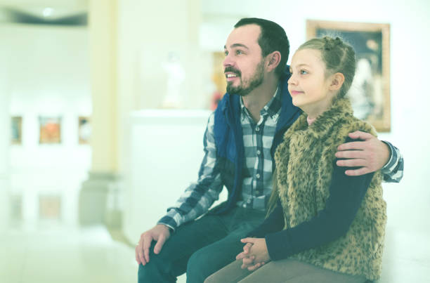 istock happy father and daughter exploring expositions in museum 1131105740