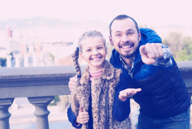 istock friendly father and daughter pointing at sight during sightseeing tour 1131105741