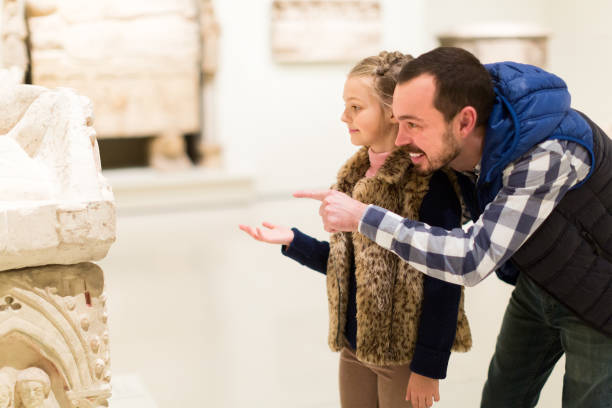 istock Smiling father and daughter regarding classical bas-reliefs in museum 1131105746