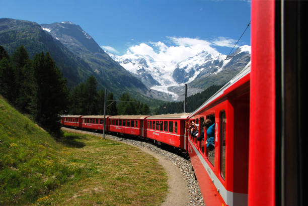 the bernina express train of the rhaetian railway, with the morteratsch glacier in the background, switzerland. - bernina express imagens e fotografias de stock