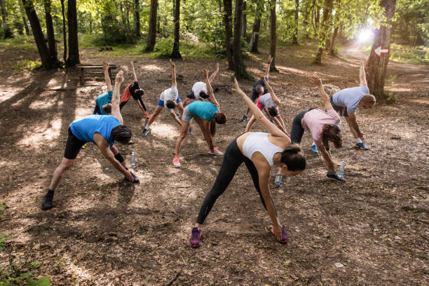 istock Above view of athletes doing stretching exercises while warming up in the forest. 1131110794