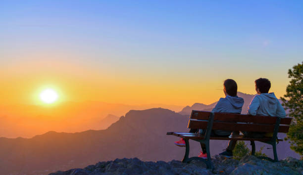 istock Romantic scene of couple watching sunrise. 1131111092