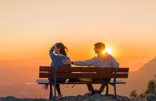 istock Romantic scene of couple watching sunrise. 1131111094