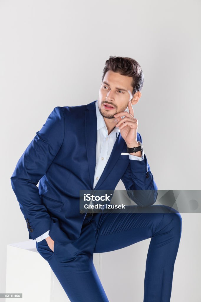 Portrait of good looking young businessman Portrait of good looking young businessman against gray background Businessman Stock Photo