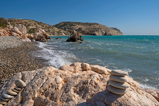 Beautiful seascape with stones on the foreground. The beach near Aphrodite birthplace in a sunny day.