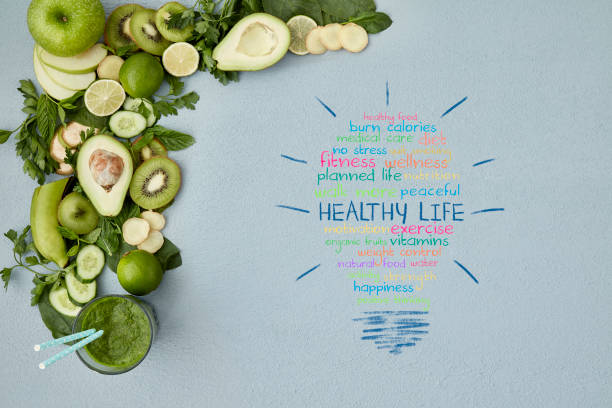 Healthy life words on table with smoothie and vegetable stock photo
