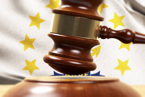 istock Wood Gavel Standing Front Of the Rhode Island State Flag Closeup 3d Render 1131111557