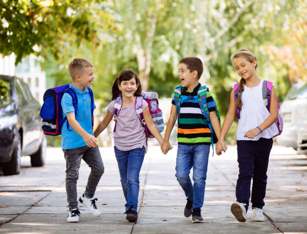 istock School children holding hands and going to school together 1131113388