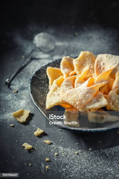 Sweet And Golden Angel Wings With Powdered Sugar Stock Photo - Download Image Now - Angel, Baked Pastry Item, Bakery