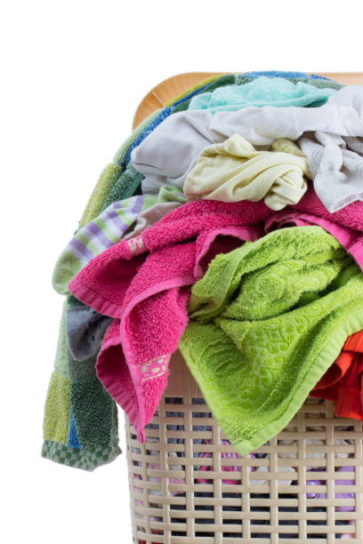 istock Laundry basket full of dirty washing (isolated on white) 1131114172