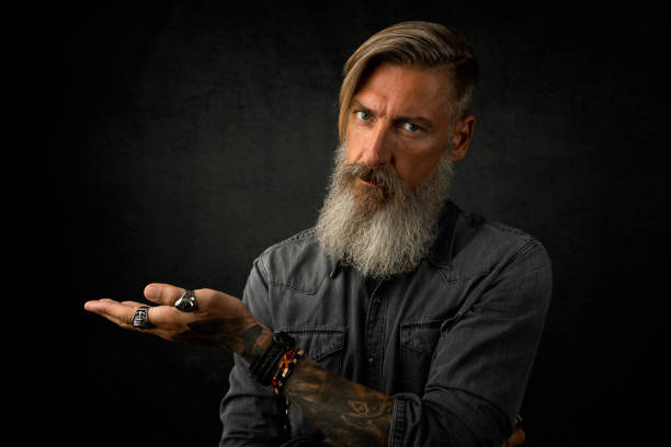 istock Portrait of a thoughtful bearded man who make a gesture with his left hand 1131117152