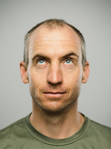 istock Portrait of real caucasian man with blank expression looking up 1131118769