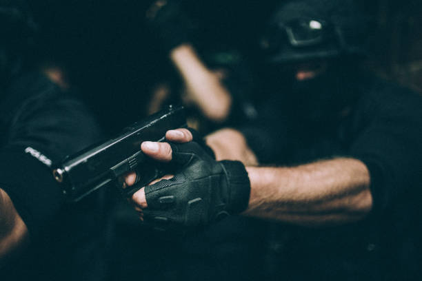 istock Police force man aiming with gun 1131118893