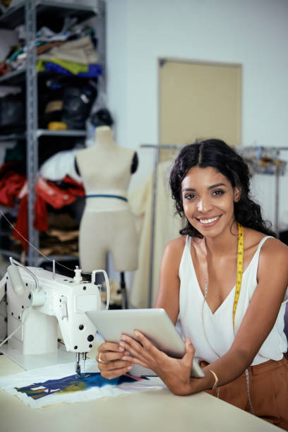 istock Pretty female tailor with tablet 1131121642