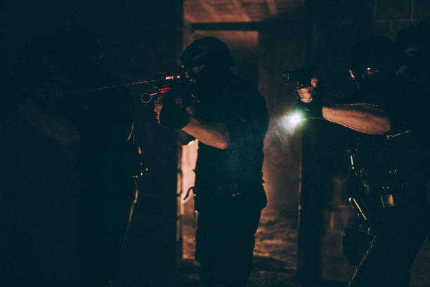istock SWAT team on a mission in dark warehouse 1131121723
