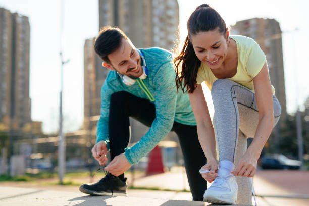 istock Runners tying running shoes and getting ready to run 1131122958