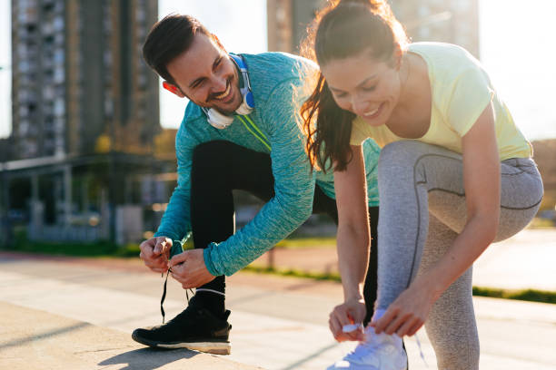 istock Runners tying running shoes and getting ready to run 1131122959