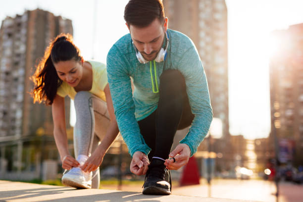istock Runners tying running shoes and getting ready to run 1131122961