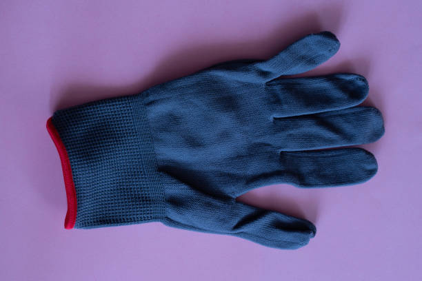 istock black work gloves on pink background. overalls and uniforms. hand protection 1131123195