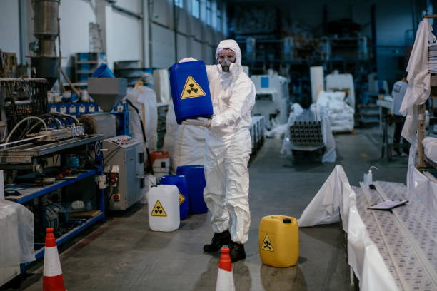 istock Factory worker wearing gas mask and radioactive protection suit 1131123323