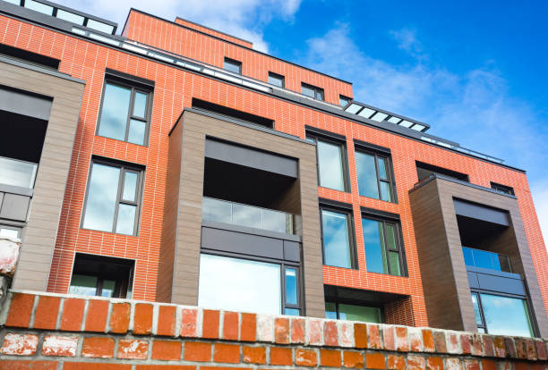 istock Modern Red Brick Apartment Complex with solid rock fence wall. Home residential buildings complex real estate. 1131123326