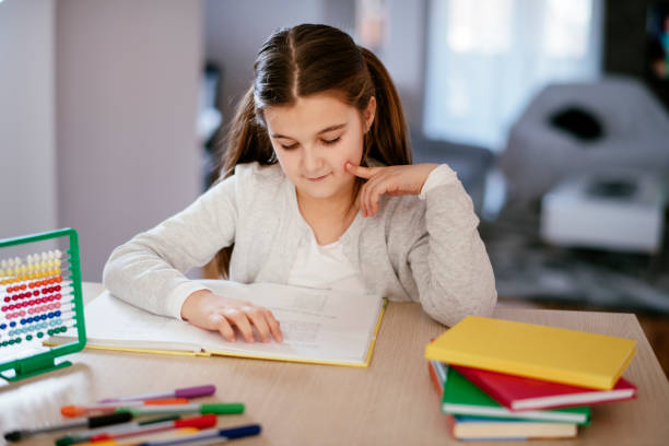 istock Beautiful girl doing homework 1131127575