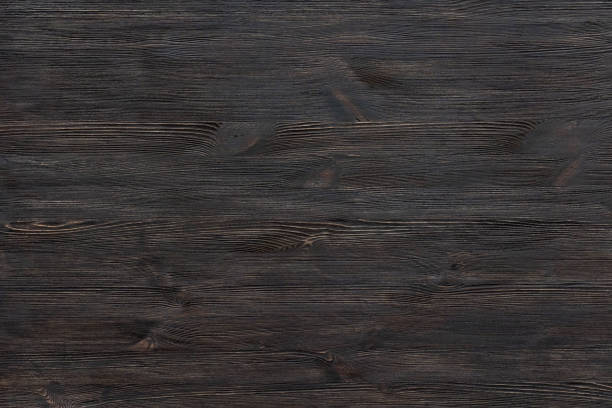istock Dark brown painted wooden desk background tabletop, rustic rough old black blank rustic wood texture timber board surface empty table structure floor plank pattern with copy free space, top view 1131127917