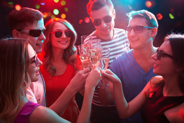 istock Young friends touching the glasses with each other 1131128790