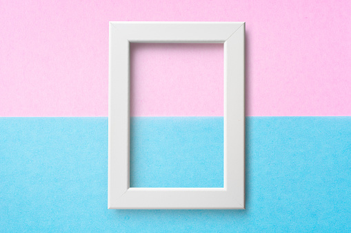 Design concept - white wood frame on blue and pink paper background for mockup