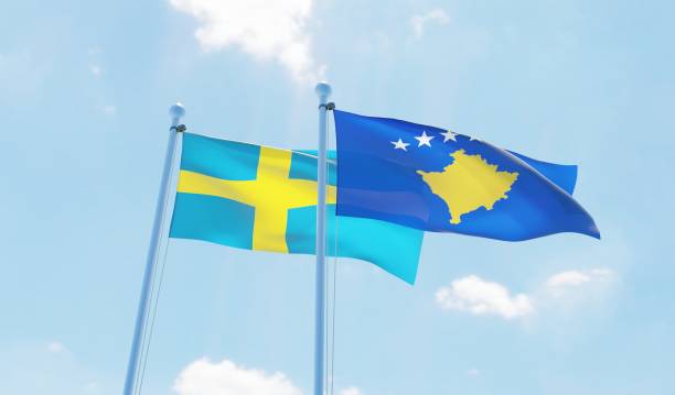 istock Kosovo and Sweden, two flags waving against blue sky 1131129667