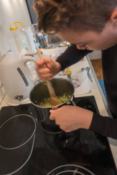 istock Young Boy Preparing Sauce for Pasta 1131130369