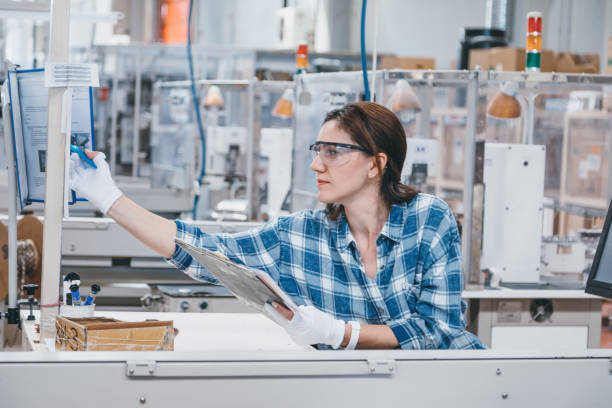 istock Female manual worker taking notes at a factory 1131130449