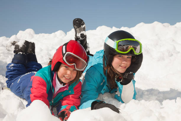 istock Sisters enjoying in the snow 1131131256