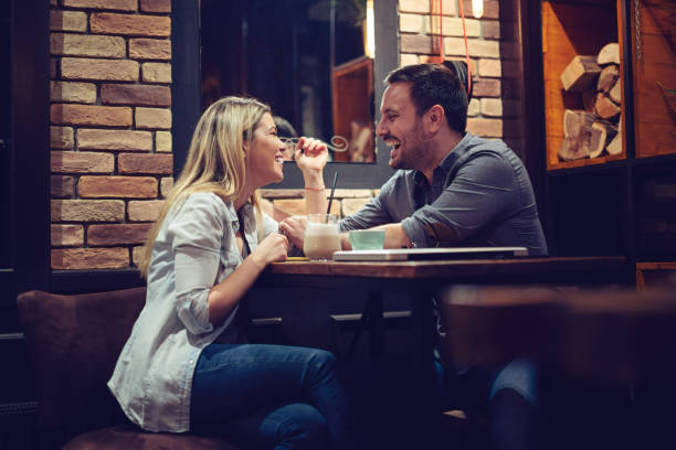 istock Couple Enjoying Evening Drinks In Bar 1131131360