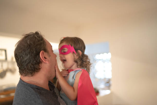 istock Father and Superhero Daughter embracing at Home 1131133151