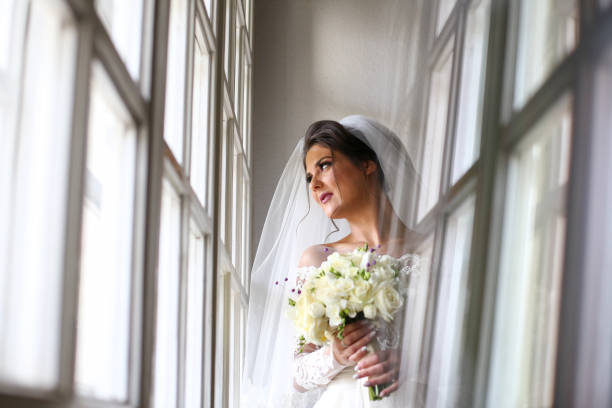 istock Elegant beautiful wedding bride posing near great window arch 1131133751