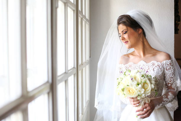 istock Elegant beautiful wedding bride posing near great window arch 1131133757