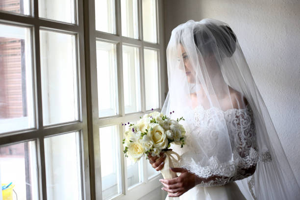 istock Elegant beautiful wedding bride posing near great window arch 1131133758