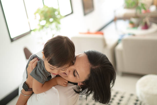 Mother and Down Syndrome Son embracing at home