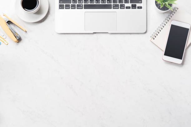 istock Stylized clean marble office working desk with smartphone, laptop, glasses and coffee cup, workspace design, mock up, top view, flat lay, copy space, close up 1131135918