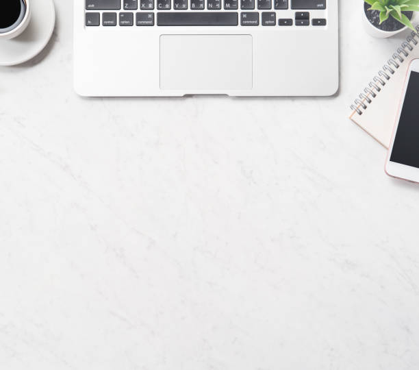 istock Stylized clean marble office working desk with smartphone, laptop, glasses and coffee cup, workspace design, mock up, top view, flat lay, copy space, close up 1131135929